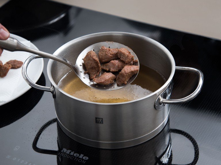 Heat oil in a large pot over medium heat and fry lamb for approx. 3 min., or until browned. Set aside.