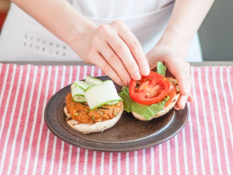 Slice other toppings and set them on a serving plate. Transfer burgers to a platter and toast buns. Serve burgers on buns topped with lettuce, cucumber, tomato slices, and sauce as desired.