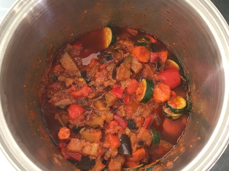 Add the eggplant, carrots, zucchini, bell peppers and mushroom to the saucepan, and cook, stirring, until softened. Continuously add the rest of the olive oil. Continue to let the sauce simmer for about 45 minutes, or until the passata is reduced and its water content has evaporated.