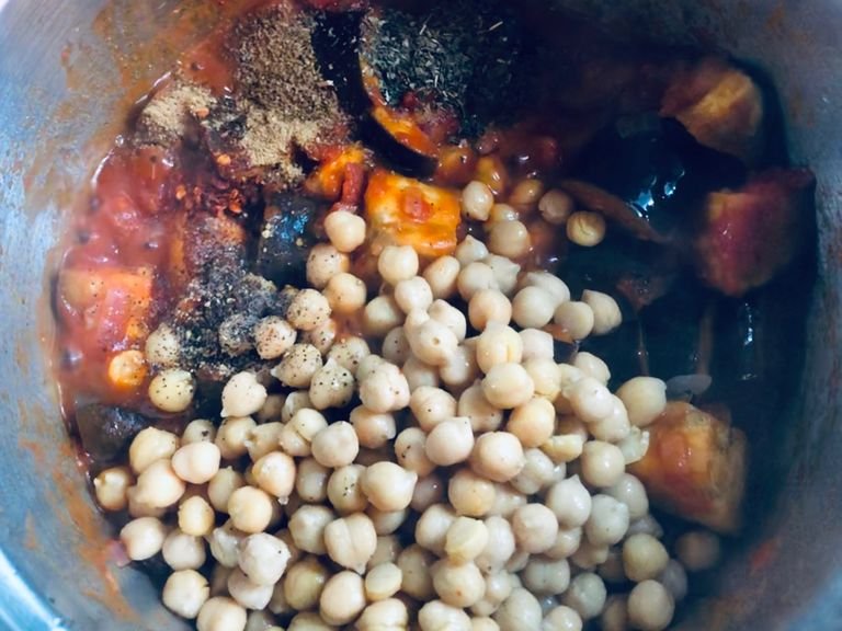 Mix in drained chickpeas, garlic, spices and herbs. Cook a few more minutes. Season with salt to taste.