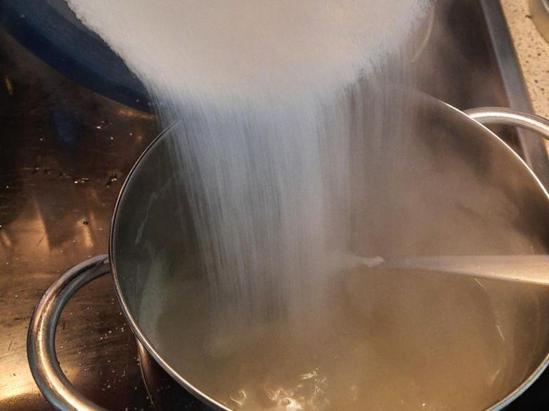 As soon as the water boils, add the sugar and stir till dissolved. Reduce heat to low and let simmer for 2 min.