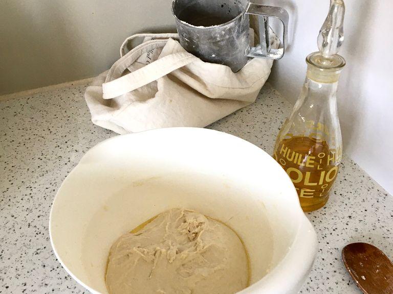To make the dough, in a bowl mix together the flour, water and yeast. Add salt and bring the dough together with a rubber spatula or a wooden spoon. Knead vigorously in the bowl unlit smooth and elastic, 4-6 min. Drizzle with some olive oil and with the help of your spatula/spoon try to coat the surroundings of the dough with oil and gradually slop the dough over the oil. Cover with a damp towel and let rise until doubled in size, approximately 3 hrs.