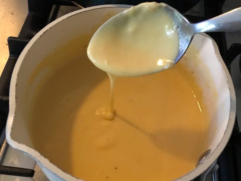 Add the slices of cheddar cheese and whisk until they’re melted in.