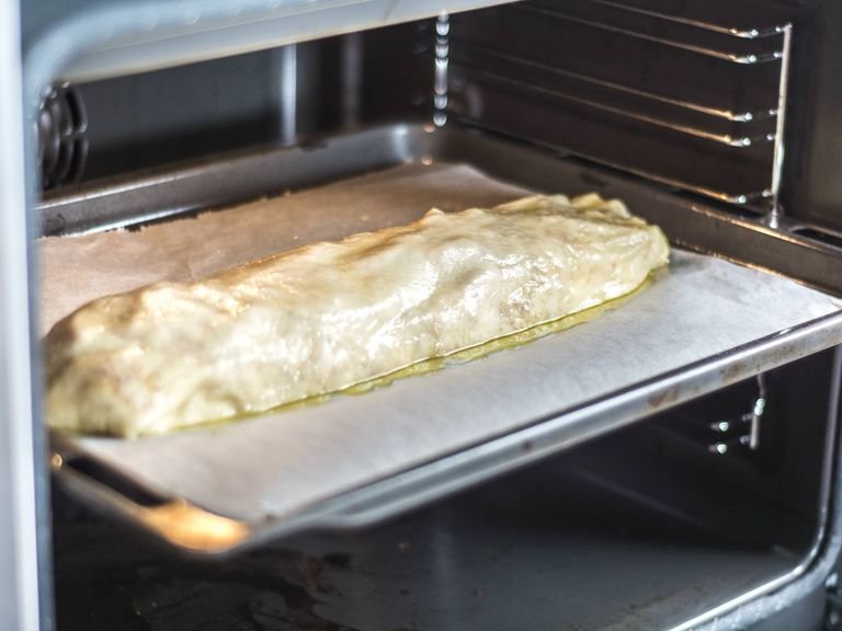 Baste the top with melted butter, place immediately into a preheated oven at 180°C/ 350°F, and bake for approx. 20 – 25 min. until golden. Dust with confectioner's sugar and serve with vanilla sauce.