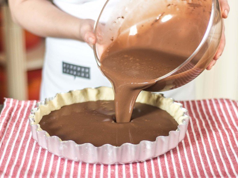 Add egg whites, eggs and a pinch of salt to the chocolate mixture and whisk. Pour the smooth mixture onto the baked base and bake the whole thing at 180°C/355°F for approx. 25 min. Leave to cool down to room temperature for approx 1 hour.