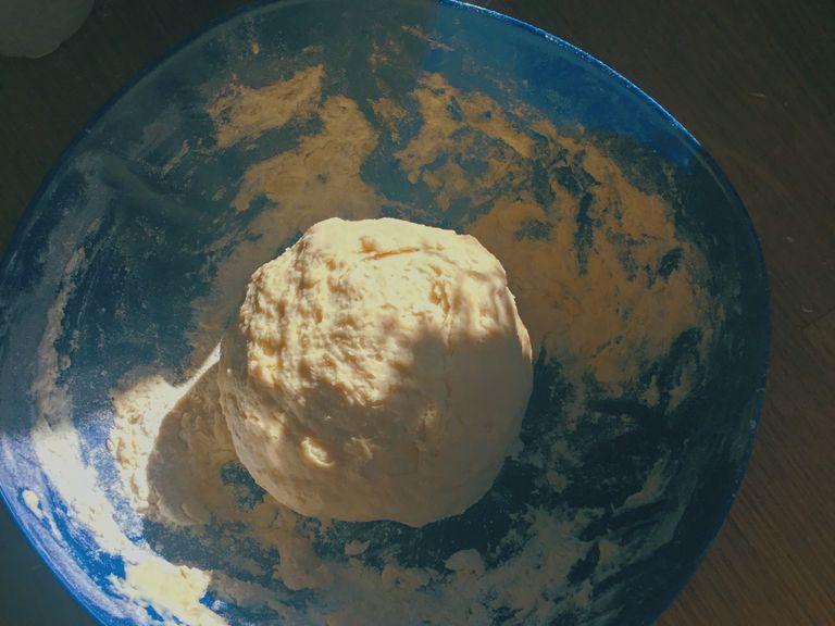 Mix the dry ingredients in a bowl. Once the milk mixture is warm, pour into the dry ingredients and mix together with your hands to create a dough.