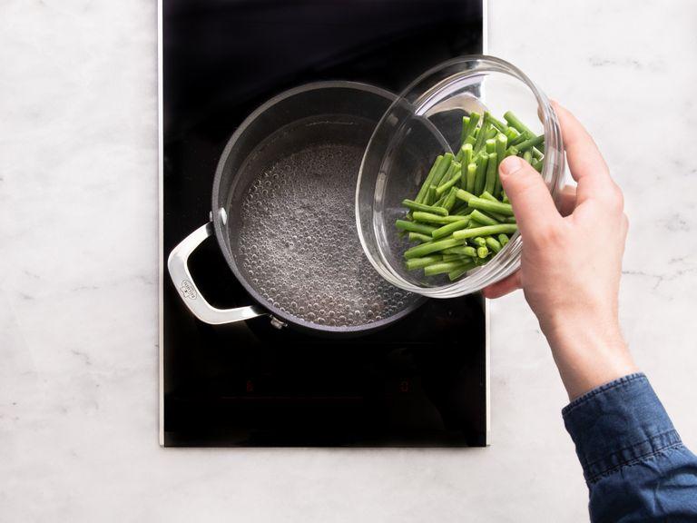 Cook potatoes in a small pot of salted water, drain, allow to cool slightly, and chop into bite-sized pieces. Blanch the green beans in a small pot with salted water until tender, but still crisp, approx. 4 min.
