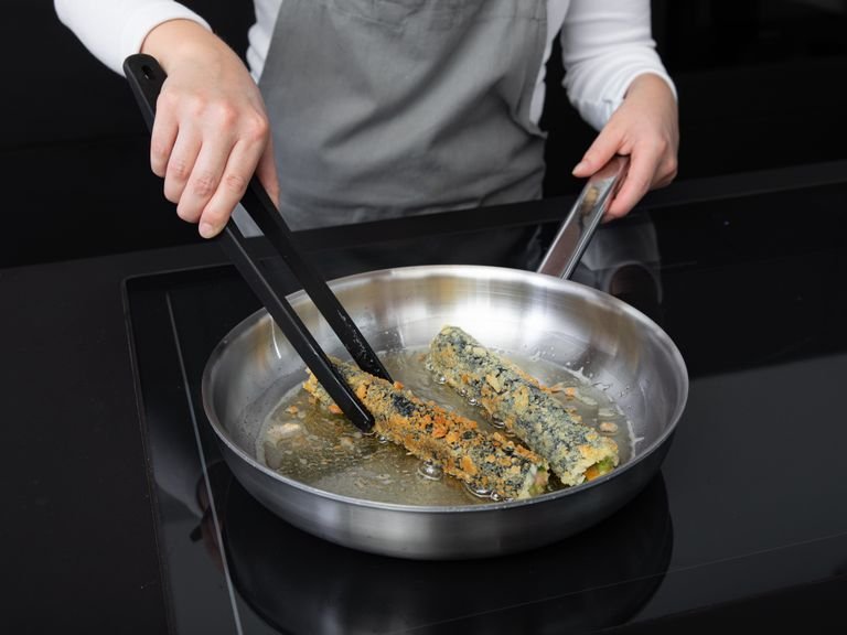 Heat vegetable oil in a large frying pan and fry the sushi rolls until browned on all sides.