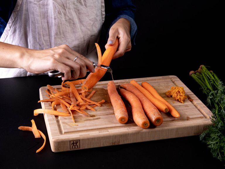 Preheat oven to 180°C/360°F. Zest and squeeze out the juice of an orange, then fillet the remaining one. Peel and cut carrots into bite-sized pieces, and arrange them on a baking sheet.