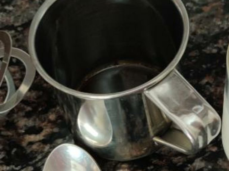 Add coffee powder, sugar and hot water in a mug.