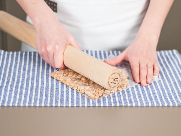 Preheat oven to 180°C / 350°F. Add hazelnuts to freezer bag and crush with rolling pin.