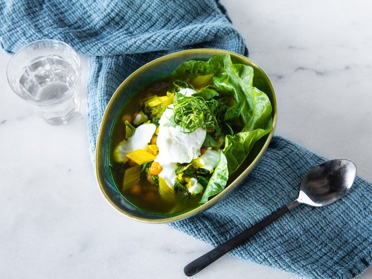 Swiss chard and chickpea stew with turmeric and poached eggs