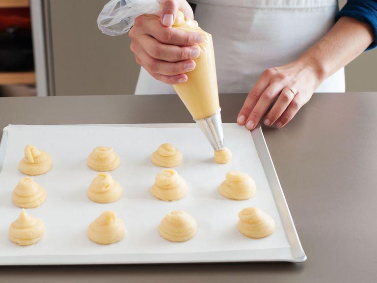 Pipe approx. 18 mounds of choux pastry (about 3.75-cm/1.5-inch wide or 2.5-cm/1-inch high) about 2.5-cm/1-inch apart onto prepared baking sheet. Bake at 220°C/425°F until golden brown, approx. 10 to 20 minutes. Turn off oven and allow to sit for another 10 minutes, with door slightly ajar. They should sound hollow when you tap the bottoms. Prick the side of each puff with a toothpick to allow steam to escape. Set aside to cool.