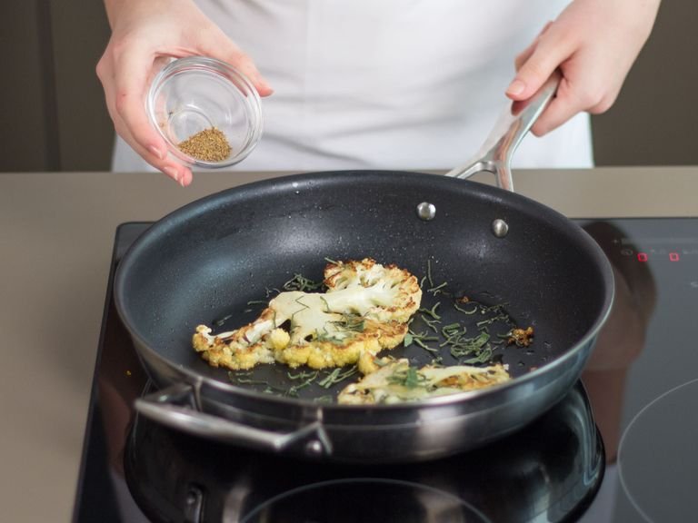 In the meantime, heat some vegetable oil in a large ovenproof frying pan. Fry cauliflower steaks over medium heat for approx. 4 - 6 min. on each side until nicely browned. Sprinkle with sage and anise.