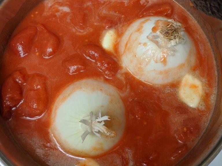 Once the sauce is simmering, turn heat down to low and continue to simmer slowly, for about 45 minutes total. Stirring, and crushing up the tomatoes, occasionally.