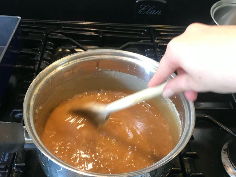 Keep stirring for 20 minutes and the mixture will turn a dark caramel colour and double its original thickness. Remove from the heat and mix the fudge with an electric hand whisk for 7-8 minutes or until it has thickened even more and is begging to set along the sides of the pan. Don’t over beat, as you don’t want it too thick. Can add any other ingredients or flavouring you are using.