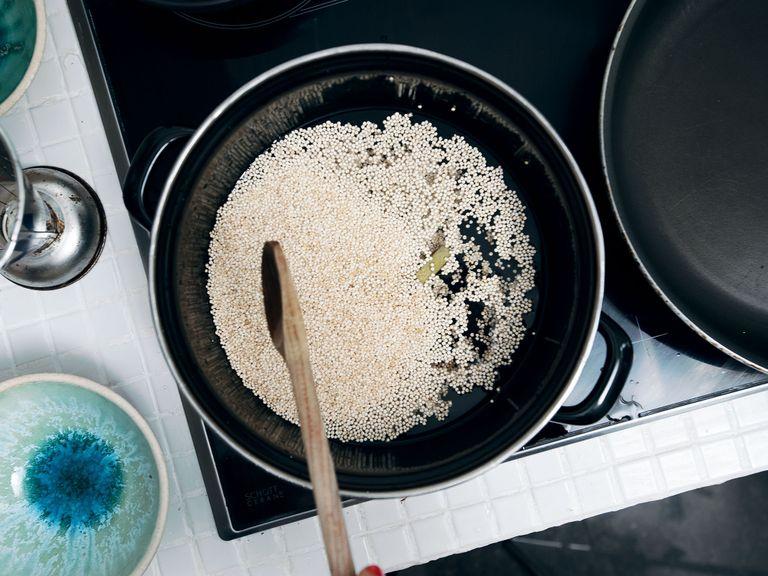 Place quinoa in sieve and run under cold water. Add fresh water to a saucepan, add quinoa and stock cube, and cook according to package instructions. Set aside.