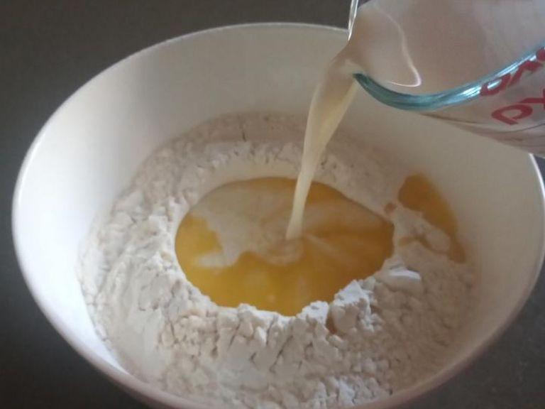 Sift flour and salt into a bowl. Make a well in the centre, and add yeast mixture and melted butter.