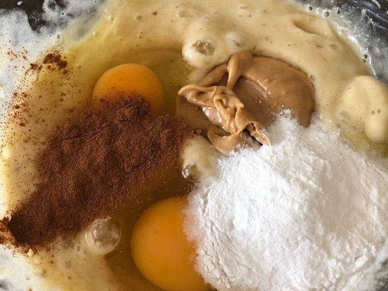 Add the eggs, ground cinnamon, peanut butter, and baking powder, then mix.