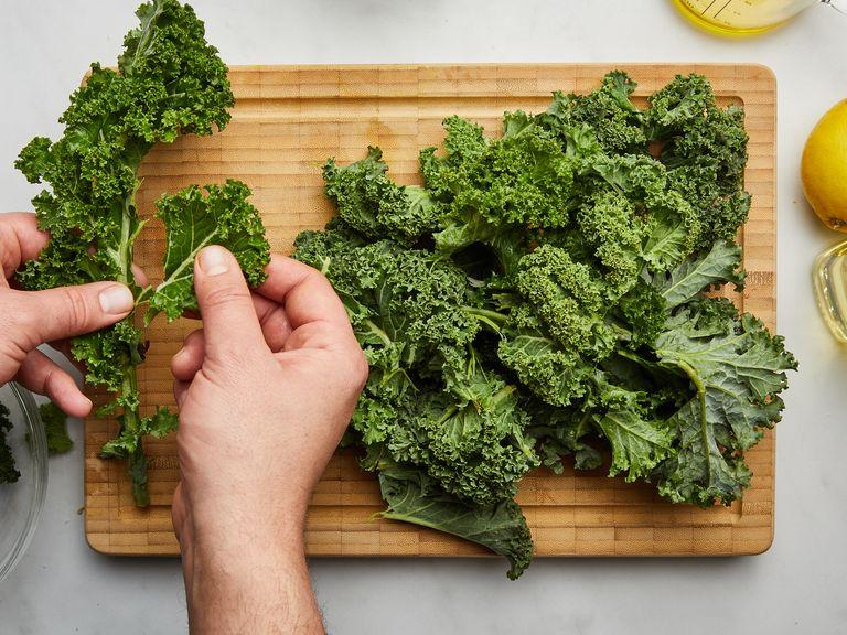 Preheat oven to 150°C/300°F. Bring a large pot of salted water to a boil. Remove kale leaves from the stem and tear into bite-sized pieces. Pluck basil leaves. Zest and juice lemon.