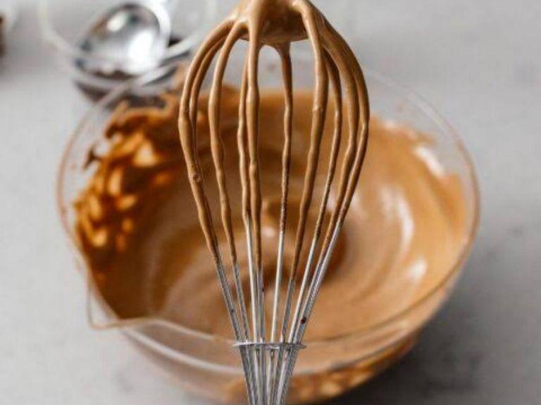 In a medium bowl, combine sugar, coffee, and water. Vigorously whisk until mixture turns silky smooth and shiny, then continue whisking until it thickens and holds its lofty, foamy shape.