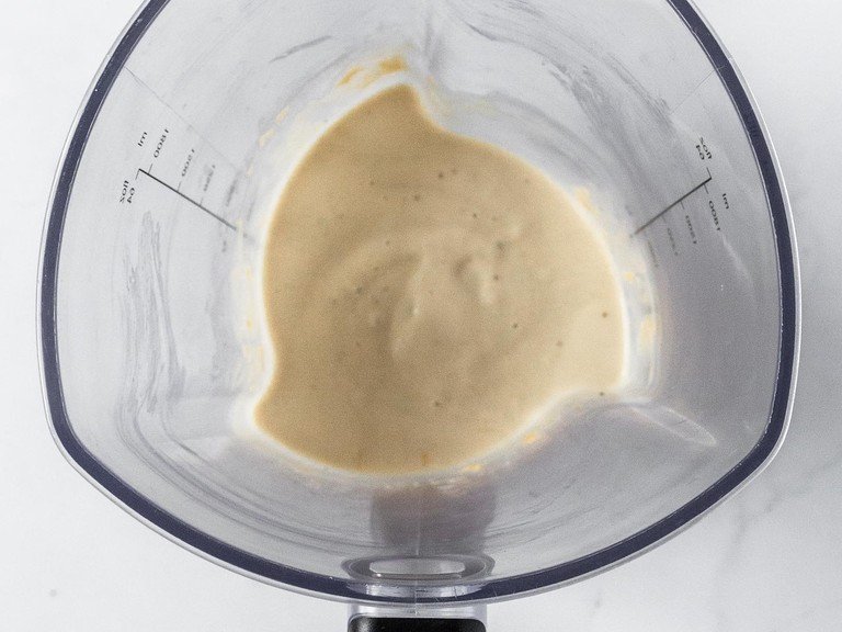 Transfer frozen bananas to a high-speed blender or food processor and add almond butter. Blend until they form a thick purée. Scrape the mixture down with a spatula or spoon occasionally to help the blending process.