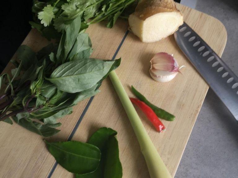 prep the base of your dish by mincing ginger and garlic, slicing the shallots, scoring the lemongrass.