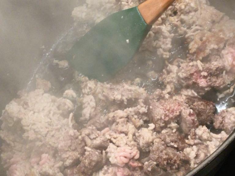 Heat some olive oil in a large heavy-bottomed pot and sear the ground meat for approx. 5 min. or until nice and brown.