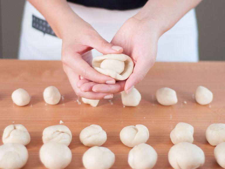 Flatten the balls from the first dough in your hand until they fit around the balls from the second dough. Wrap the flattened discs around the balls firmly.
