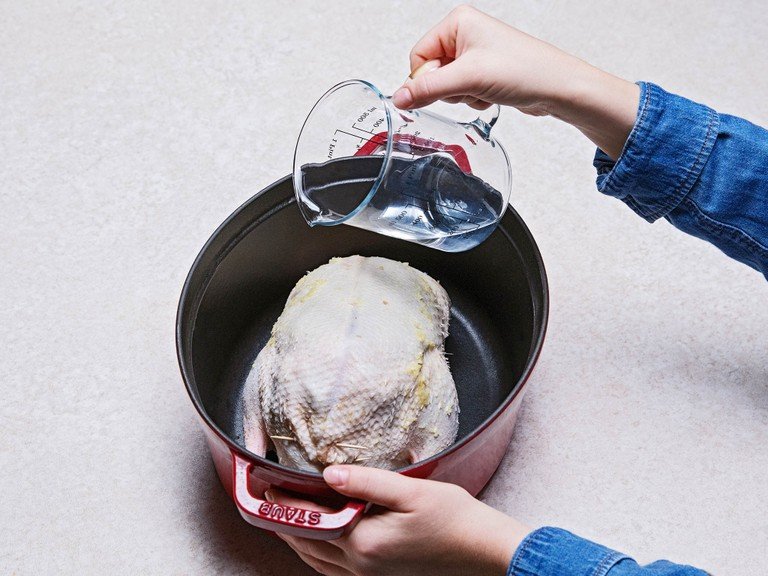 Transfer duck to a roasting pan. Add water and roast, covered, at 180°C/360°F for approx. 2.5 hrs. Remove the lid and turn the oven to 200°C/390°F. Continue roasting for approx. 40 min., or until the duck is cooked through and golden brown.