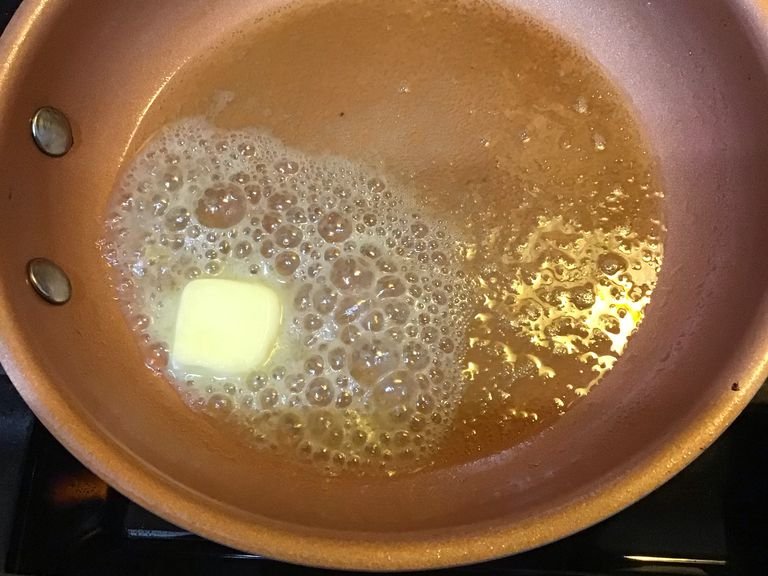 Set a frying pan on medium heat until butter is melted, then turn it to between medium and low setting. 