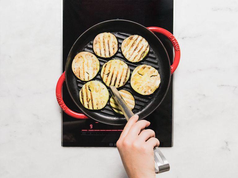 Add eggplant slices in one layer to a preheated, greased grill pan and grill on both sides until soft. Keep working in batches until all the eggplant slices are grilled. Set aside.