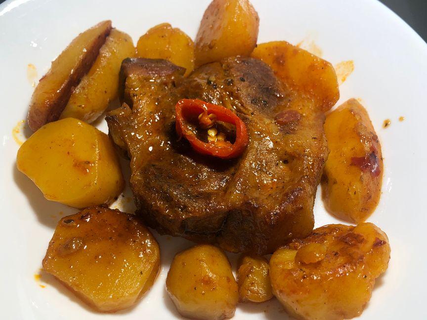 Oven roast pork shoulder with potatoes