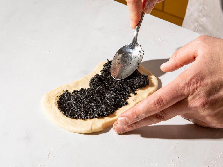 To make the black sesame paste, add black sesame seeds to a food processor and blend until finely ground. Then add remaining sugar and butter and pulse into a smooth paste. On a floured work surface, divide dough into 10 equal pieces. Roll each piece into a small rectangle. Spread some black sesame paste over the dough, leaving a small border around.