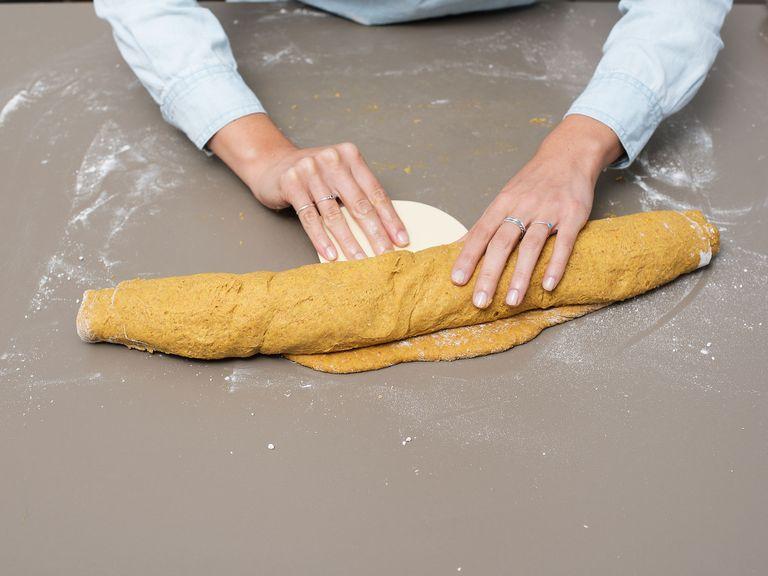 Roll the dough tightly from the long side as you would a carpet, then cut into twelve even pieces. Then place the pumpkin cinnamon rolls with a little space in a large springform pan and let rise again for 40 min. Meanwhile, preheat oven to 180°C/350°F.
