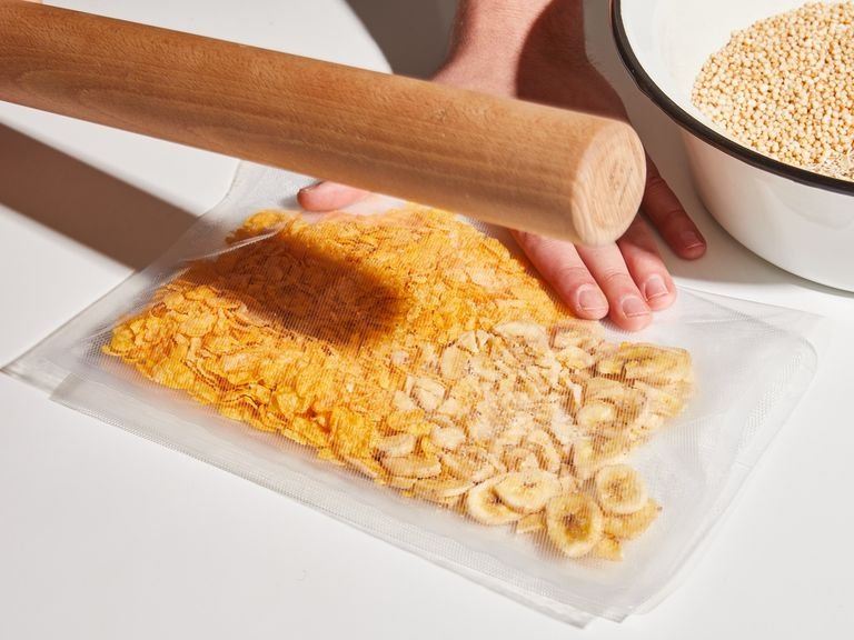Transfer dried bananas and cornflakes to a resealable bag. Seal, removing as much air as possible, then crush everything until quite small with a rolling pin (you could also use a food processor). Transfer to a bowl with oats and puffed quinoa and mix to combine.