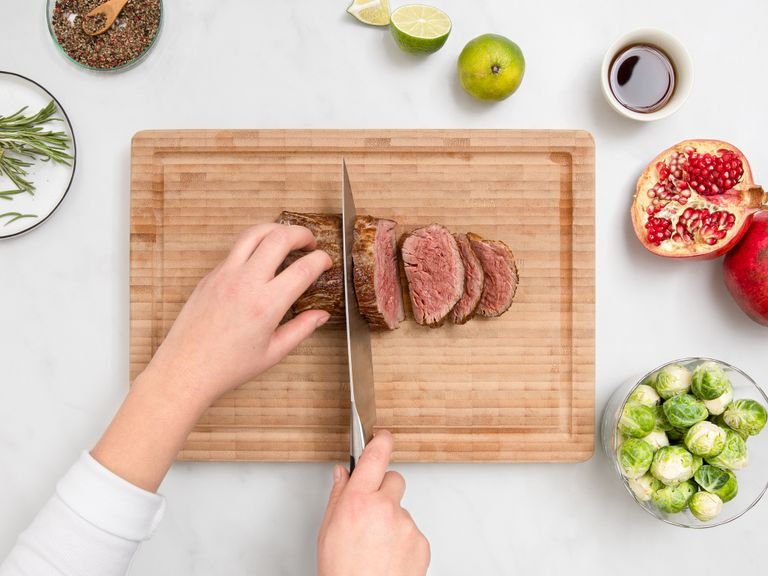 Slice beef fillet and season with salt and pepper.  Serve on a platter with Brussels sprouts, and drizzle with pan juices, pomegranate seeds, and mint leaves. Serve and enjoy!